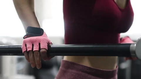 Young athletic woman doing exercise for training triceps dips on parallel bars 動画素材 285118926