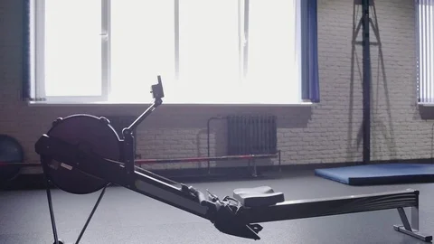 Young athletic woman doing rowing machine workout at the gym Vídeos de archivo 94130227