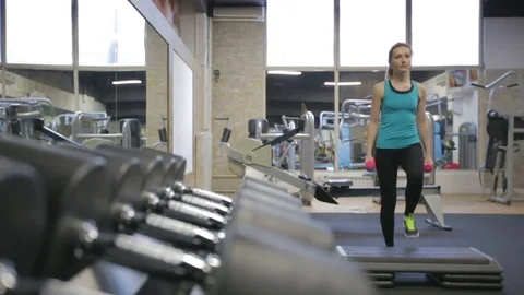 Young athletic woman exercise step-ups with dumbbells, camera slider Stock Footage 71609069