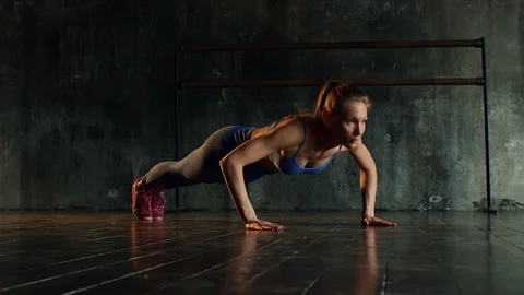 Young athletic woman is pressing her body from the floor in gym Stock Footage