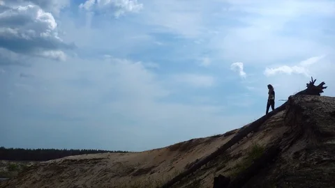 A young athletic woman walks on top of the Hill Stock Footage