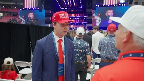 A young attendee in a red cap in the crowd at the Charlie Kirk memorial service Stock Footage 345297844