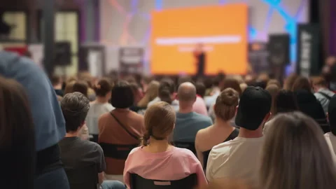 Young attendees absorb information at a technology talk, presenter with visual Stock Footage 268871293