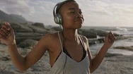Young Attractive African American Woman Wearing Headphones Listening To Music Stock Footage