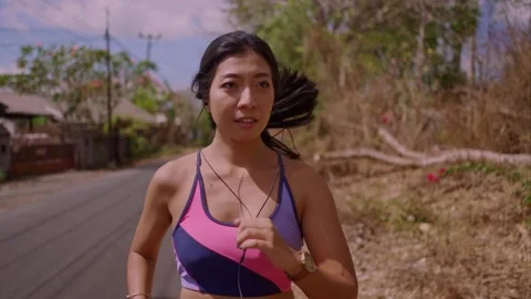 Young attractive and active runner woman running and jogging at countryside road Stock Footage 131803534