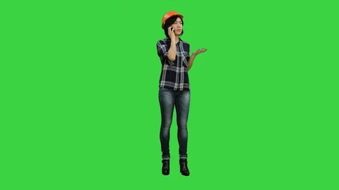 Young attractive asian engineer woman standing having a phone call on a Green Stock Footage