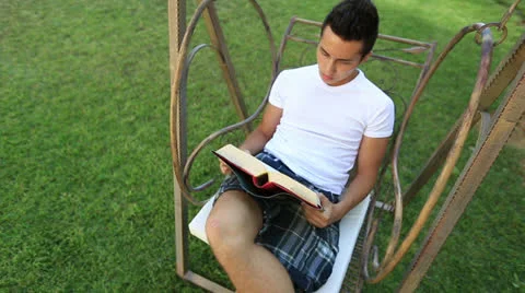 Young attractive boy reading book2 Stock Footage 25423258
