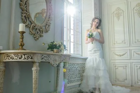 Young attractive bride on wedding gown in studio Stock Photos