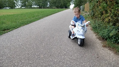 Young Attractive Child Boy Driving With Electric Toy Scooter and got a Accident  Stock Footage 114012865
