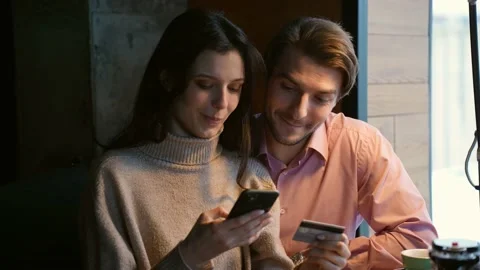 A young attractive couple communicates through a video call with friends in a Stock Footage 168102598