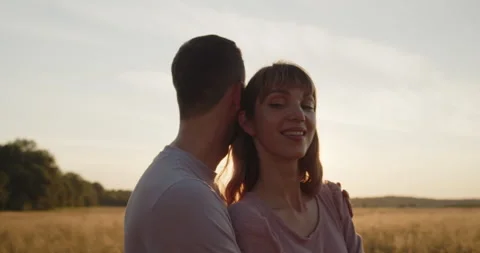 Young attractive couple having a date at sunset in a golden wheat field 動画素材 237810820