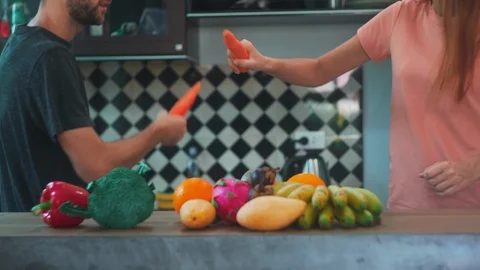 Young Attractive Couple Having fun with Vegetables in Kitchen. Stock Footage 114667006
