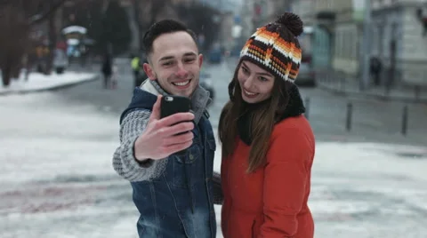 Young attractive couple making faces on camera. Man and woman taking photographs Stock Footage 59953752