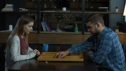 Young attractive couple playing backgammon Stock Footage 87254281