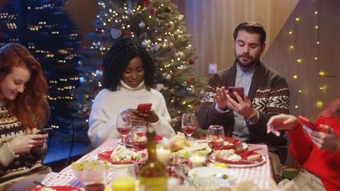 Young attractive diverse people using smartphones at table, busy messaging or Stock Footage 121593023