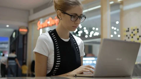 Young attractive freelancer using laptop on open space. Stock Footage 109046727