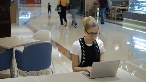 Young attractive freelancer using laptop on open space. Video stock 109049402