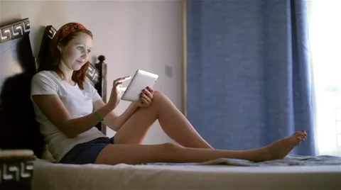 Young attractive girl using tablet computer screen touchpad smiling enjoy life Stock Footage 48700668