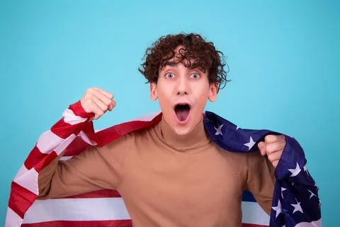 Young attractive guy with a flag posing in the studio. Stock Photos