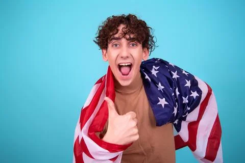 Young attractive guy with a flag posing in the studio. Stock-Fotos
