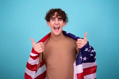 Young attractive guy with a flag posing in the studio. Stock Photos