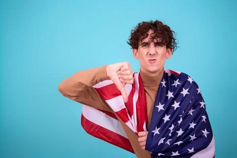 Young attractive guy with a flag posing in the studio. Stock Photos