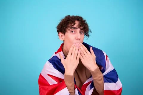 Young attractive guy with a flag posing in the studio. Stock Photos