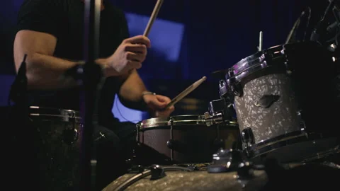 A young attractive guy plays a drum kit. Strikes a cymbal. Performance of a rock Stock Footage 231440782