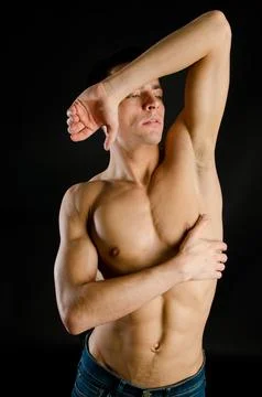 Young attractive guy posing in the studio. Beautiful body. Stock-Fotos