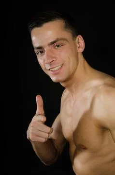 Young attractive guy posing in the studio. Beautiful body. Stock Photos