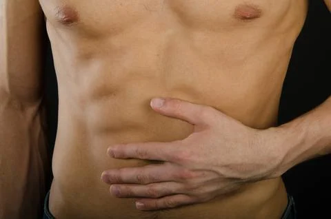 Young attractive guy posing in the studio. Beautiful body. Stock Photos
