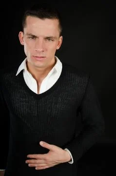 Young attractive guy posing in the studio. Beautiful body. Stock Photos