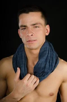 Young attractive guy posing in the studio. Beautiful body. Stock Photos