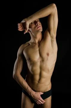 Young attractive guy posing in the studio. Beautiful body. Foto stock
