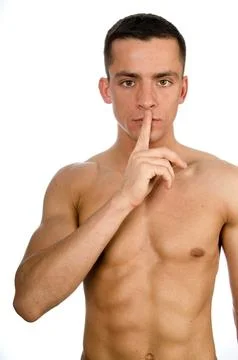 Young attractive guy posing in the studio. Beautiful body. Stock Photos