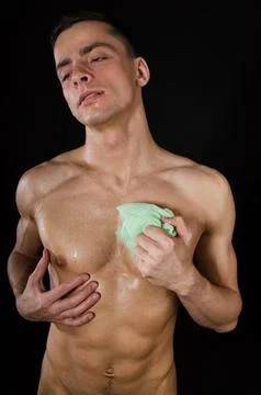 Young attractive guy posing in the studio. Beautiful body. Stock Photos