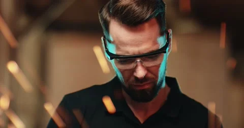 A young attractive guy in protective glasses is concentrating on cleaning a Video stock 167370335
