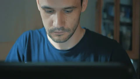 Young attractive guy working on his laptop. Young guy programmer creates code Stock Footage 155552106