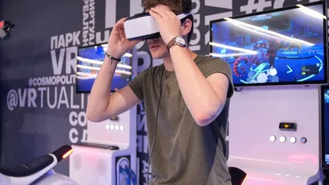 Young attractive handsome guy rides a motorcycle in virtual reality. Holidays Stock Footage 113976335