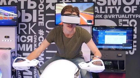 Young attractive handsome guy rides a motorcycle in virtual reality. Holidays Stock Footage 113997625