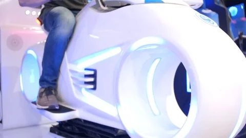 Young attractive handsome guy rides a motorcycle in virtual reality. Holidays Stock Footage 113998035