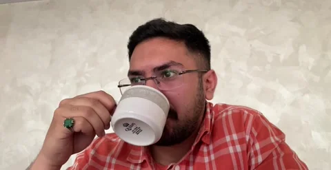 Young attractive Handsome Man drinking Tea , Coffee Stock Footage 235833079