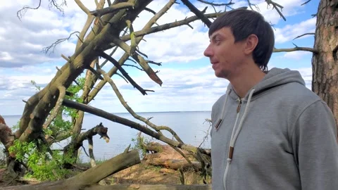 Young attractive man of 30 years spending leisure time in beautiful pine forest Stock-Footage 131436645