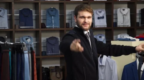 Young attractive man with a beard, dressed in a business suit, dancing in a men Stock Footage 63354703