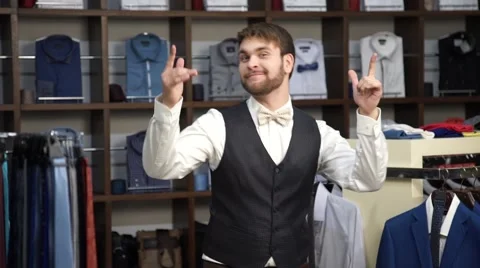 Young attractive man with a beard, dressed in a business suit, dancing in a men Stock Footage 63354955