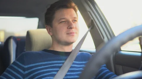 A young attractive man is drinking coffee in car Video stock 87348160