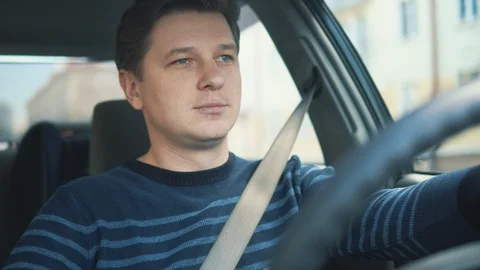 A young attractive man is drinking coffee in car Stock Footage 87350994