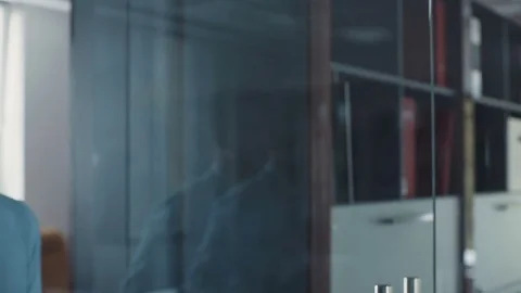 A young attractive man goes to the hall in the modern office. Business center Stock Footage