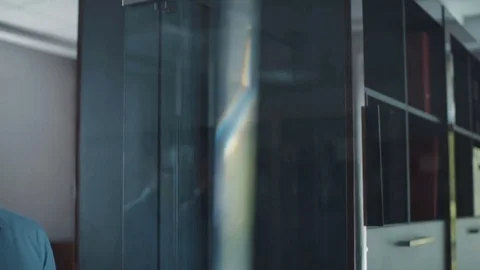 A young attractive man goes to the hall in the modern office. Business center Stock Footage