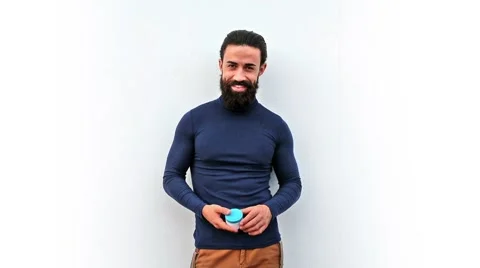 Young attractive man holding a cosmectic bottle Stockbeeldmateriaal 58663064